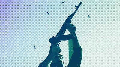 An opposition fighter fires his AK-47 in the air in celebration after opposition forces took control of the city in Damascus, 8 December 2024